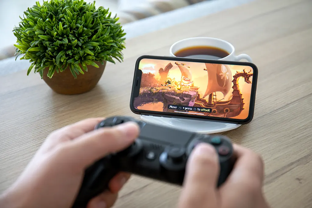 A PS4 controller and a smartphone being paired.